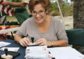 Miami Customer Relations Coordinator Mirtha Uriarte commemorates the hike with a special cancellation stamp.
