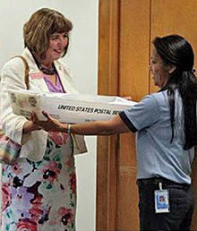 Helen Simmons, left, presents letters for military recruits to Colorado Springs, CO, Retail Associate Agnes Martin.