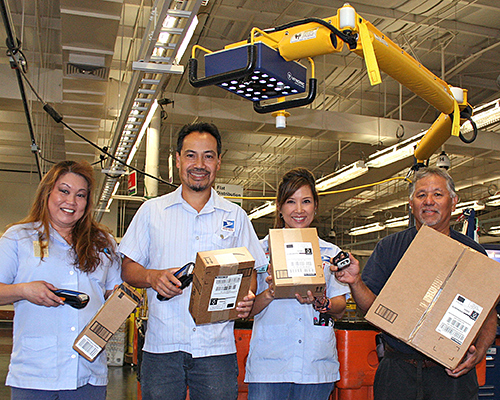 Honolulu District employees scan packages.