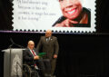 Maya Angelou’s son Guy Johnson (seated) and grandson Colin Johnson address the audience during the dedication ceremony.