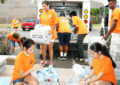 Employees and volunteers sort donations in Pearl City, HI.