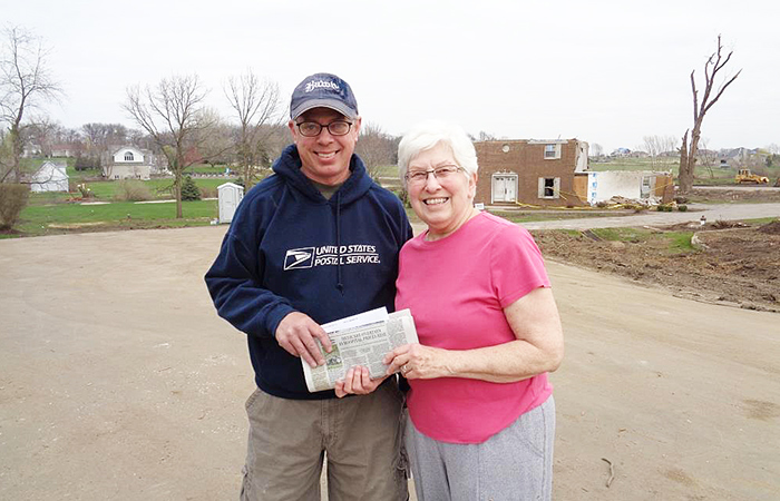 Rochelle, IL, Rural Carrier Joel Reese and a customer whose home was damaged by a tornado