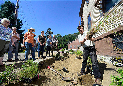 Landscape architect Tom Benjamin discusses the “rain garden” being planted at the Hinsdale, NH, Post Office Sept. 17. Photo: Battleboro Reformer