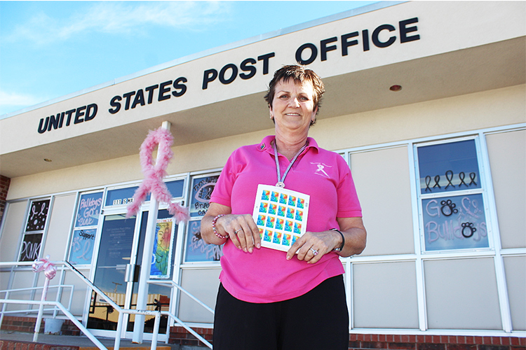 Carl Junction, MO, Postmaster Sharon Clark helps promote the Breast Cancer Research stamp.