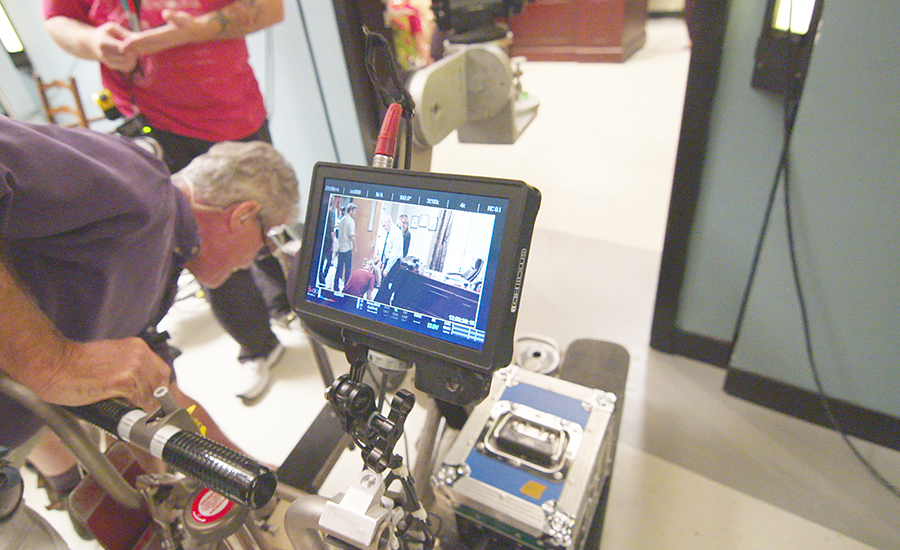 A crew member works behind the scenes on “The Inspectors.”