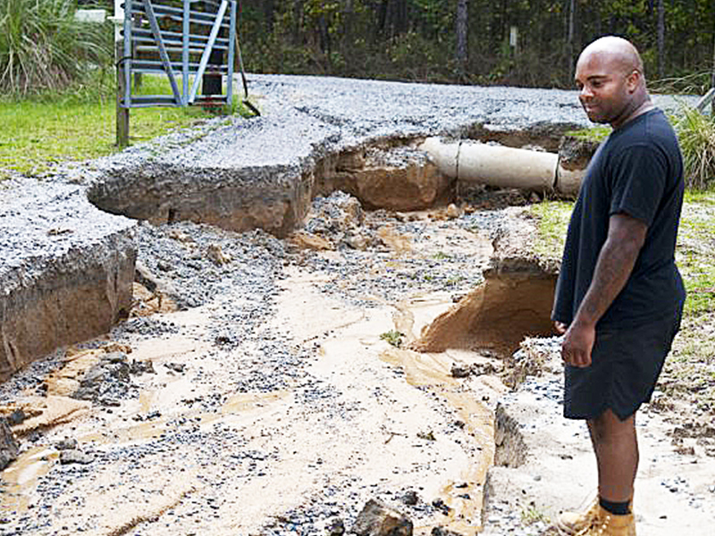 Eastover, SC, resident Marcus Bostic surveys the damage to his driveway this week.