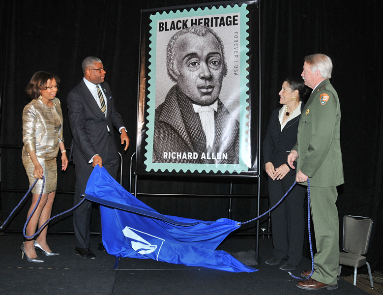At an Association for the Study of African American Life and History event, DPMG Ron Stroman unveils the stamp with association leaders Sylvia Cyrus and Evelyn Brooks Higginbotham and National Parks Service Director Jonathan Jarvis.