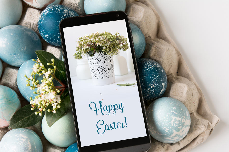 A cellphone with an image of a planter and the words: Happy Easter and a multitude of blue Easter eggs.