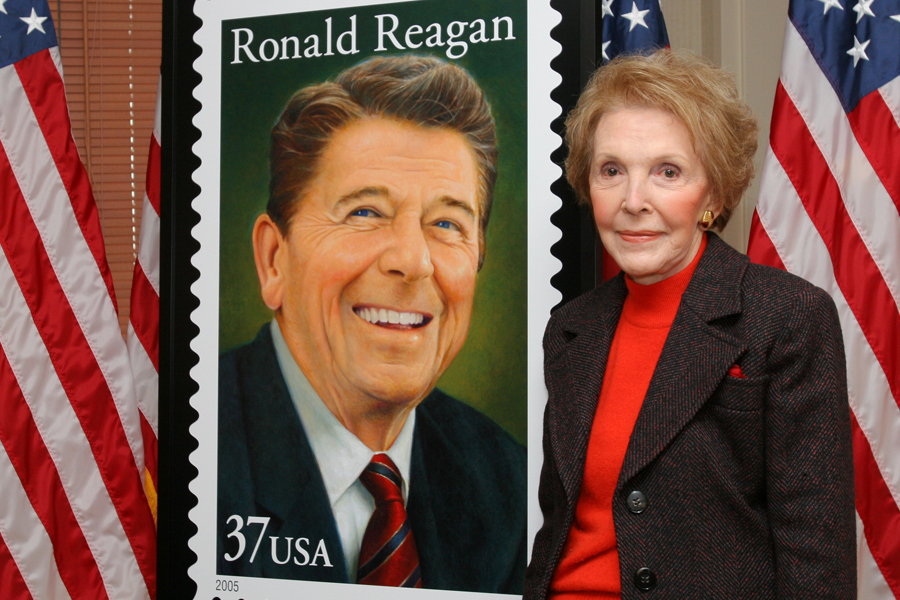 Nancy Reagan stands near the first Ronald Reagan stamp in 2004.