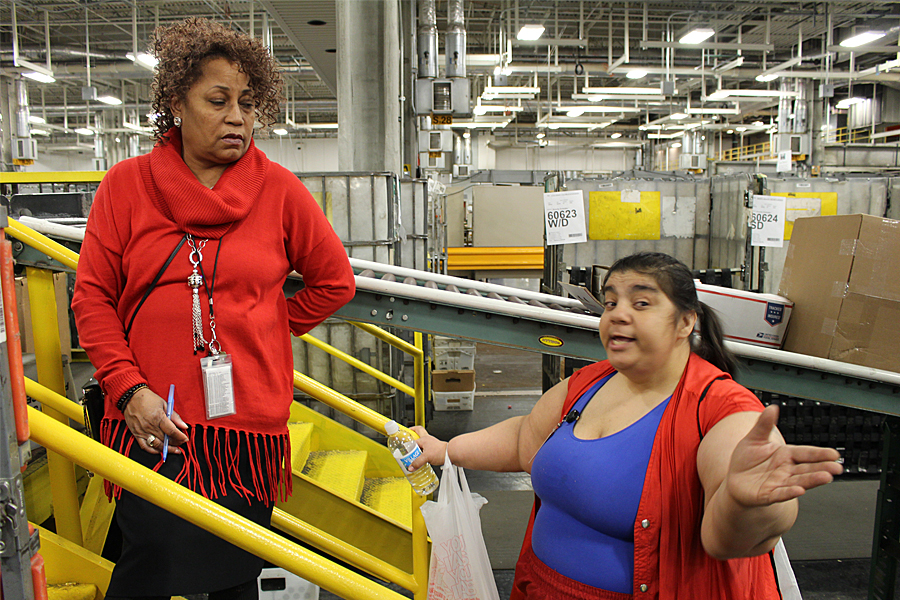 Greater Indiana District Distribution Operations Manager Cherie Harwell, a member of the team helping Chicago District strengthen service, speaks to Parcel Post Distribution Clerk Linda Starr at the Cardiss Collins Processing and Distribution Center.