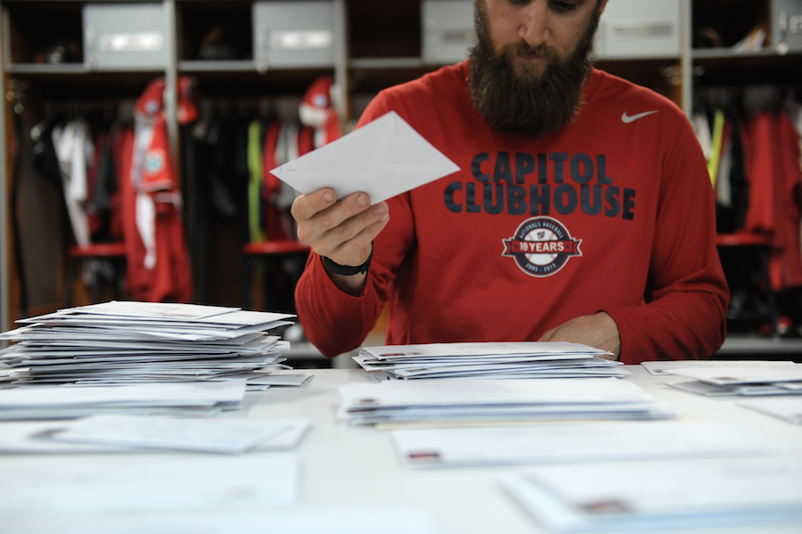 Team assistant Andrew Melnick sorts fan mail in the Washington Nationals clubhouse.
