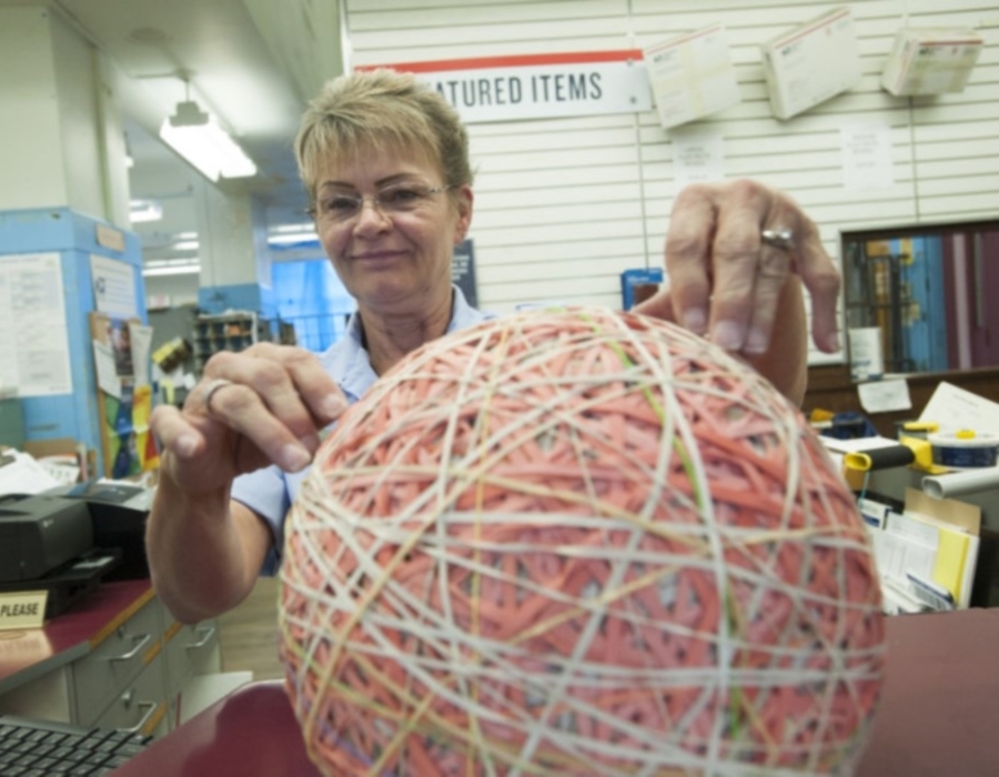 Vancouver, WA, Retail Associate Connie Brown examines her rubber band ball.