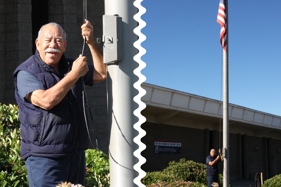 El Cajon CA Building Maintenance Custodian Rudy Renteria lowers the American flag as postal facilities that are open are required to fly the POW-MIA flag on May 30.