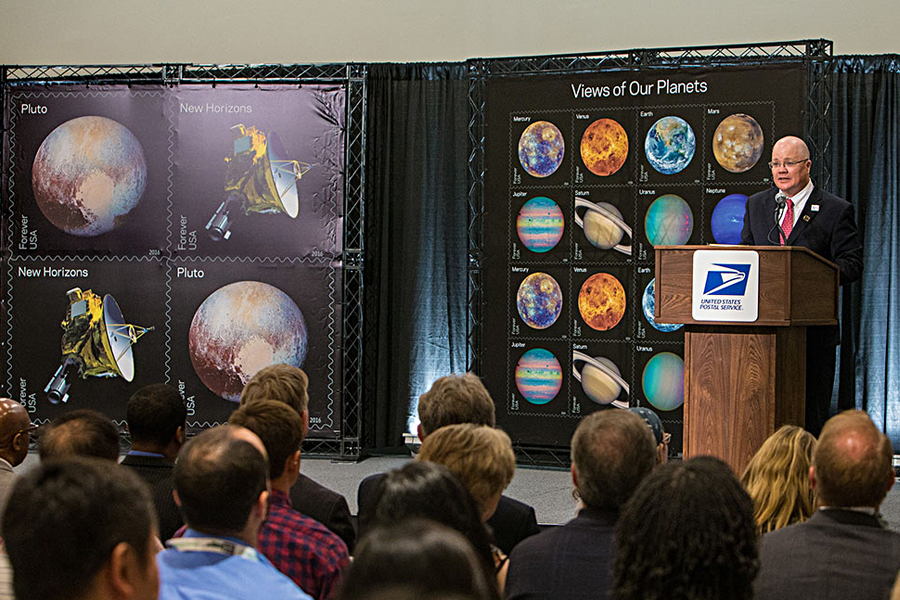 Chief Operating Officer David Williams dedicates the Pluto — Explored! and Views of Our Planets stamps May 31 at the World Stamp Show.