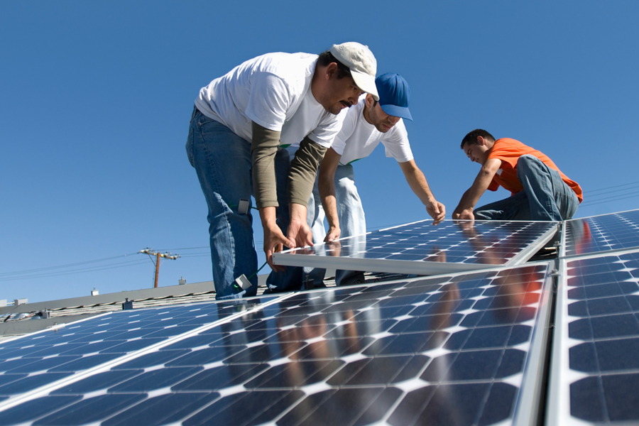 Men installing solar paneling