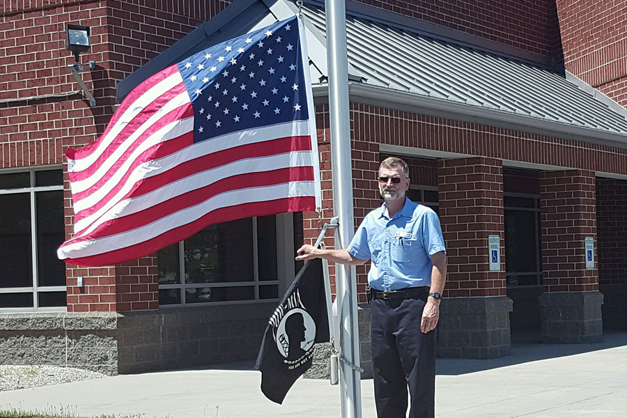 Fremont, OH, Custodian Mark Venis prepares to raise the U.S. and POW-MIA flags.