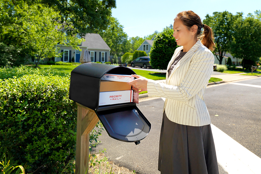 A customer retrieves mail and packages from one of the new mailboxes.
