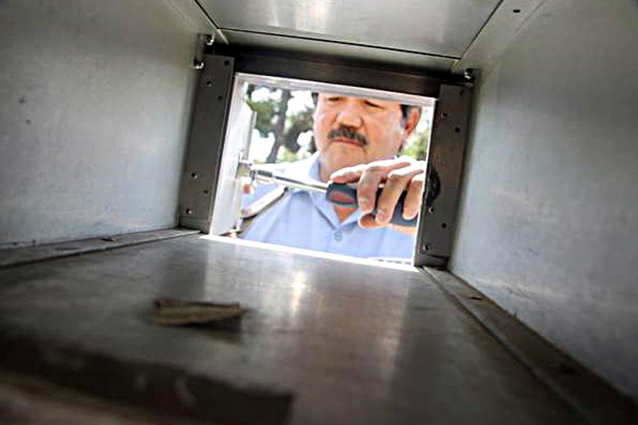 David Garcia changes a lock in Nevada-Sierra District, where he is one of eight maintenance mechanics who change more than 3,000 locks a month.