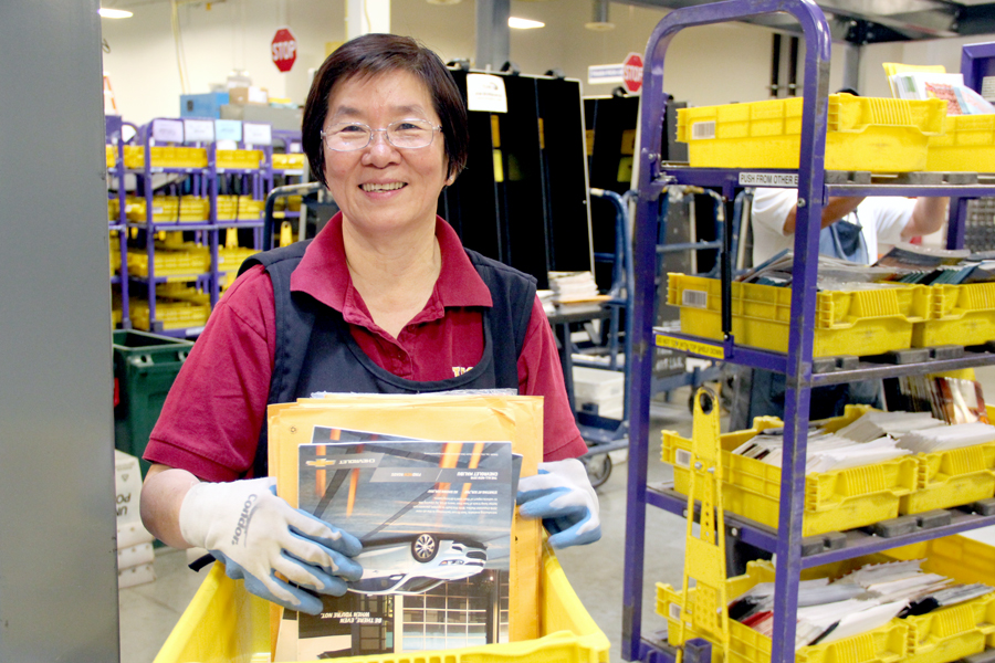 Anaheim, CA, Mail Processing Clerk Donna Ho works with the Flats Sequencing System.