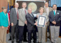 Ceremony participants display a certificate. From left: Janet Klug, chair of the Citizens Stamp Advisory Committee; Glen Fountain, a NASA project manager; James Green, NASA’s director of planetary science; Stern; PMG Megan J. Brennan; Cochrane; and Jimmy Coggins, official adjudicator for Guinness World Records.