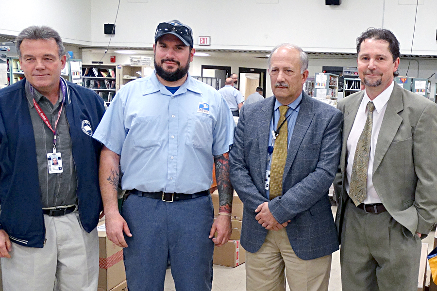 Buffalo, NY, Letter Carrier Joseph Moskal is honored at a recent ceremony. From left: National Association of Letter Carriers Branch 3 President Larry Kania, Moskal, Postmaster Thomas Szklarz and Westside Station Customer Services Manager Paul Urbanski.