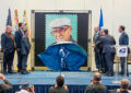 Unveiling the stamp are, from left, math teacher Camilo Joya Diaz, King, Jaime Escalante II, Cintron, Olmos and Roger C. Rocha Jr. and Brent A. Wilkes of the League of United Latin American Citizens.