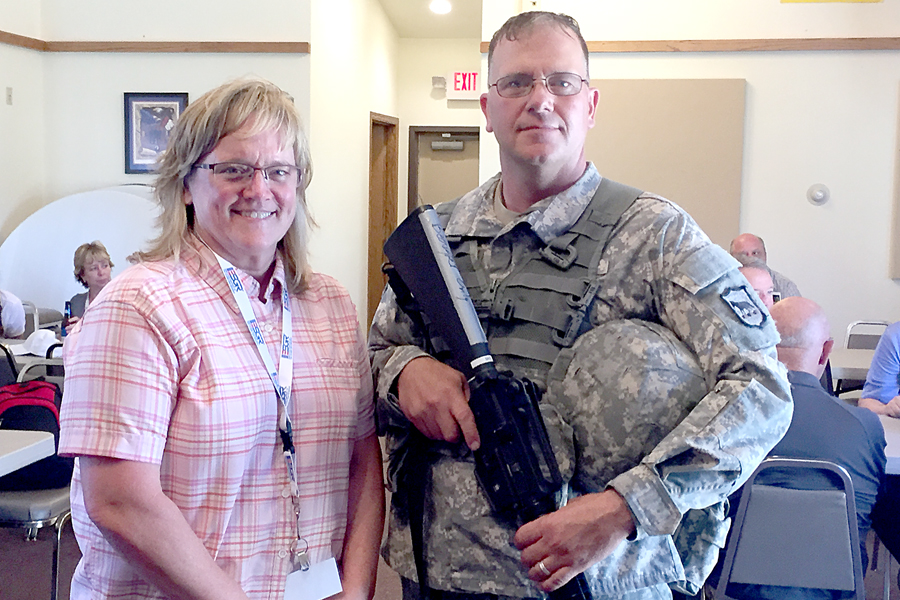 Hot Springs, SD, Postmaster Marcia Kenobbie and Letter Carrier Jeffrey Beougher, a member of the South Dakota National Guard.