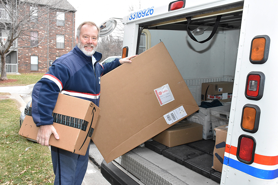 Omaha, NE, Letter Carrier Andy Zimmerman gets ready to deliver packages during last year’s holiday season.