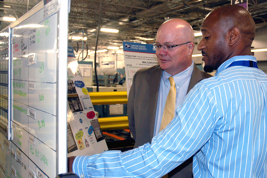 Chief Operating Officer David Williams views performance scores with Supervisor James Hopkins at the Suburban Maryland Processing and Distribution Center recently.