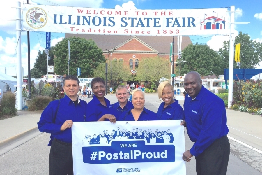 Promoting direct mail at the recent Illinois State Fair are, from left, Central Illinois District sales team members Syed Kaleemulla, Nayesa Land, George Steimer, Michele McDaniel, Sylvia Allen-Hoover and Charles Williams.