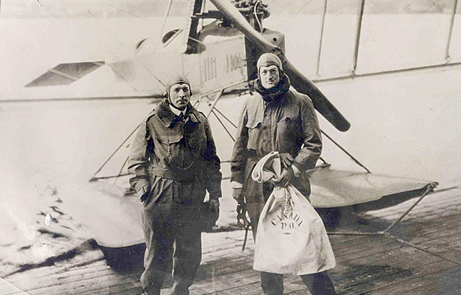 Eddie Hubbard, left, and William E. Boeing stand in front of a Boeing C-700 seaplane near Seattle after returning from a survey flight to Vancouver, BC, in 1919. They brought with them a pouch with 60 letters, making this the first international mail flight.