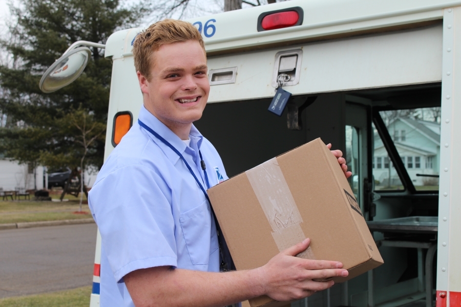 Sandusky, MI, City Carrier Assistant Max Martin delivers a package, one of several USPS services praised this week by the Houston Chronicle.