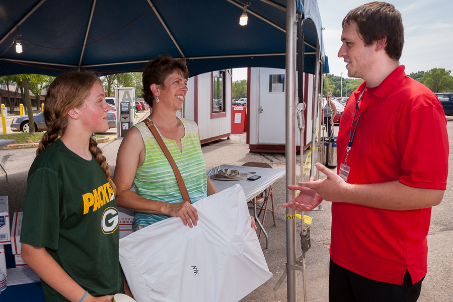 Letter Carrier Steve Walsh, right, talks with customers at the recent Dane County Fair in Madison, WI.