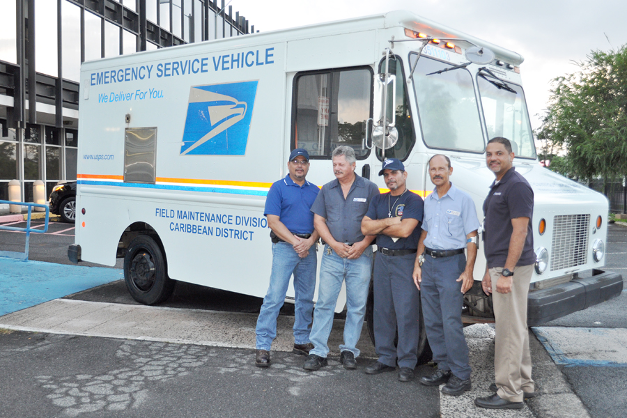Employees who helped keep the mail moving during the outage include, from left, area maintenance specialists Felix Flores, Reinaldo Ortiz, William Garcia and Luis Lozada, and Ellery Ramos, a field maintenance operations manager.