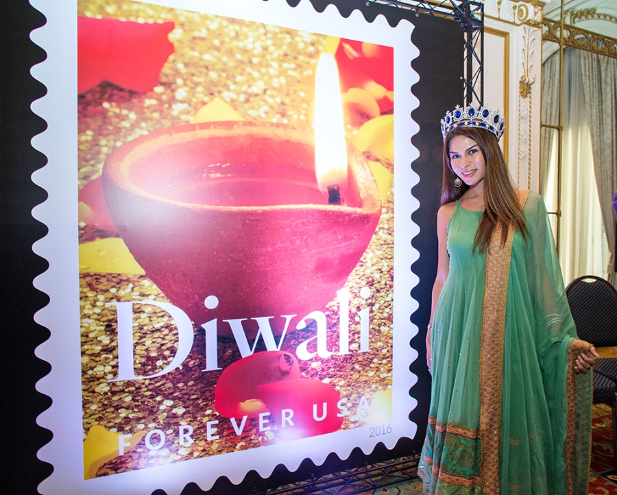 Paris Keswani, this year’s Mrs. India Earth International, stands near an image of the Diwali stamp at the Oct. 5 dedication ceremony.