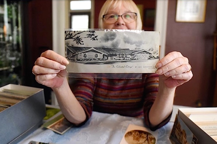 Beverly Tetterton, who has been collecting postcards since she was a child, holds a card that shows a picture of her sister’s first house. Image: StarNews