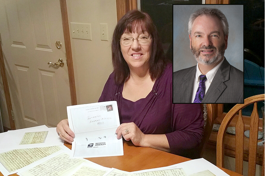 Postmaster Lori Boes displays a copy of the envelope she received containing the Civil War-era letters. Stephen Kochersperger, a USPS senior research analyst who helped solve the mystery surrounding the letters, is shown in the inset image.