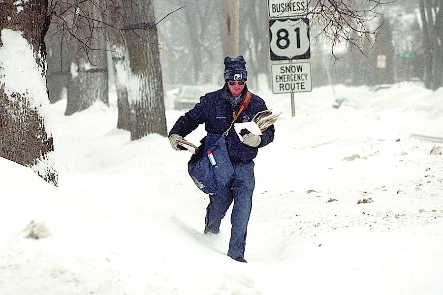 A letter carrier delivers mail Dec. 23, 1996. Image: The Dickinson Press