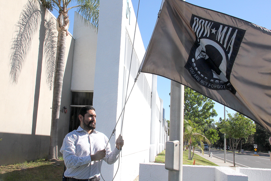 Maintenance Supervisor Santana Bahena, who served in the U.S. Navy, raises the POW-MIA flag recently at the Santa Ana, CA, Processing and Distribution Center.