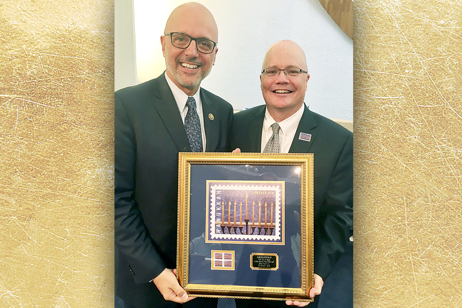 U.S. Rep. Ted Deutch of Florida and Chief Operating Officer David Williams display framed Hanukkah stamp artwork.