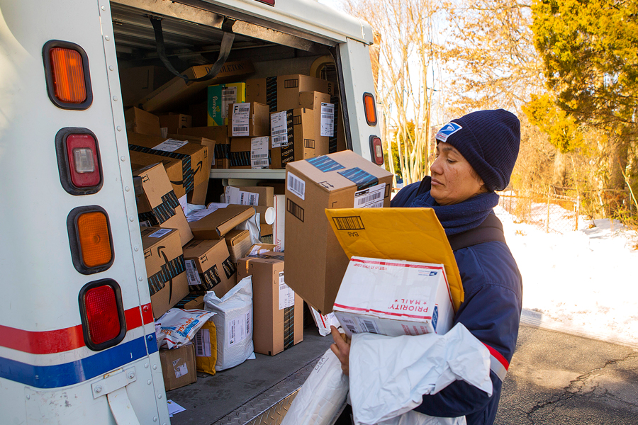It’s shaping up to be another busy holiday season for employees like Alexandria, VA, Letter Carrier Cruz Rivera, shown making deliveries earlier this year.
