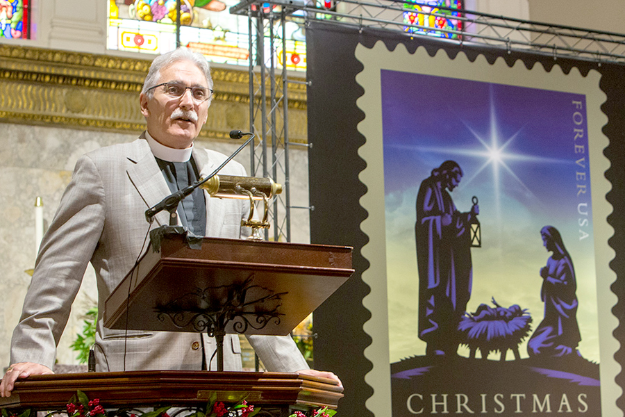 The Rev. Dr. Luis León, rector of St. John’s Church in Washington, DC, speaks at the Nov. 3 dedication of the Nativity stamp.
