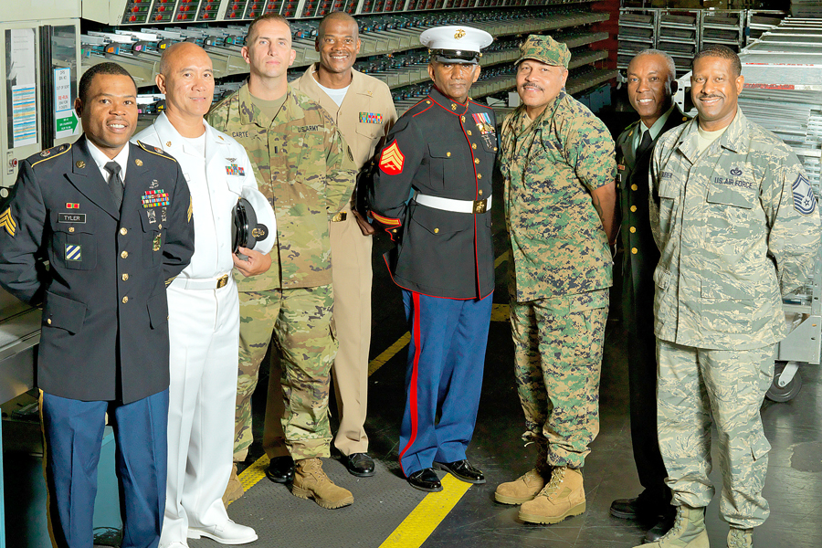 The many Postal Service employees who have served in the military include, from left, Joseph Tyler (Falls Church, VA, Post Office), U.S. Army; Generoso Cosio (Postal Police), U.S. Navy; Mitchell Carte II (Manassas, VA, Post Office), U.S. Army; Terrell Hill (Lanham, MD, Post Office), U.S. Navy; Damon Bailey (Washington, DC), U.S. Marines; Troy Keller (Arlington, VA, Post Office), U.S. Marines; Peter Miller (Bethesda, MD, Post Office), U.S. Army; and Gregory Suber (Laurel, MD, Post Office), U.S. Air Force.