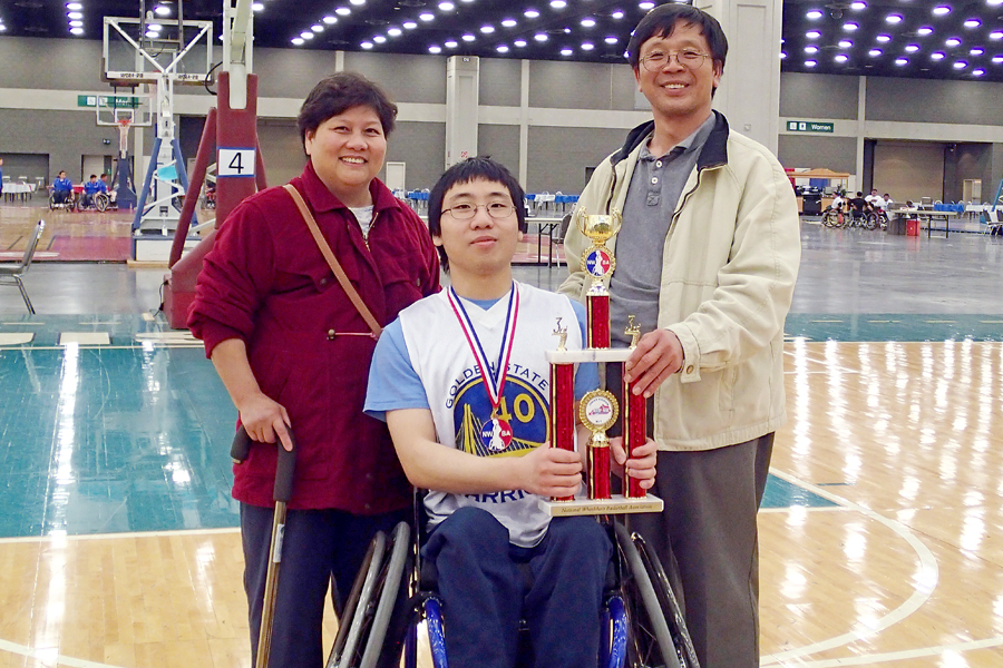 El Cerrito, CA, Letter Carrier David Luong and his wife, Hue, pose with their son, William, and one of his basketball trophies.