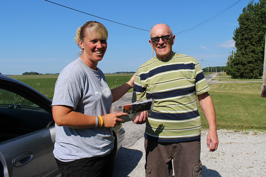 Customer John Lewis greets Windfall, IN, Rural Carrier Angela Kemper-Grimes, one of many employees who gave back to their communities this year.