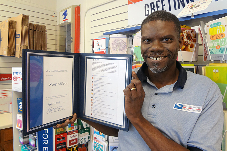 Nashville, TN, Retail Associate Kerry Williams displays a certificate of appreciation he received this year after customers praised him on social media.