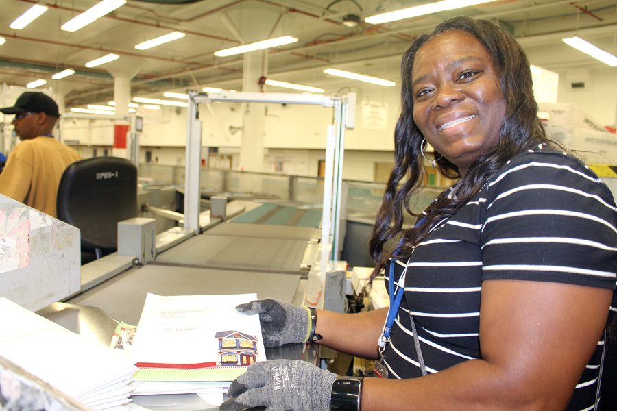 Mary Ivory, a clerk at the Detroit Processing and Distribution Center, is helping USPS process and deliver an estimated 750 million packages this holiday season.