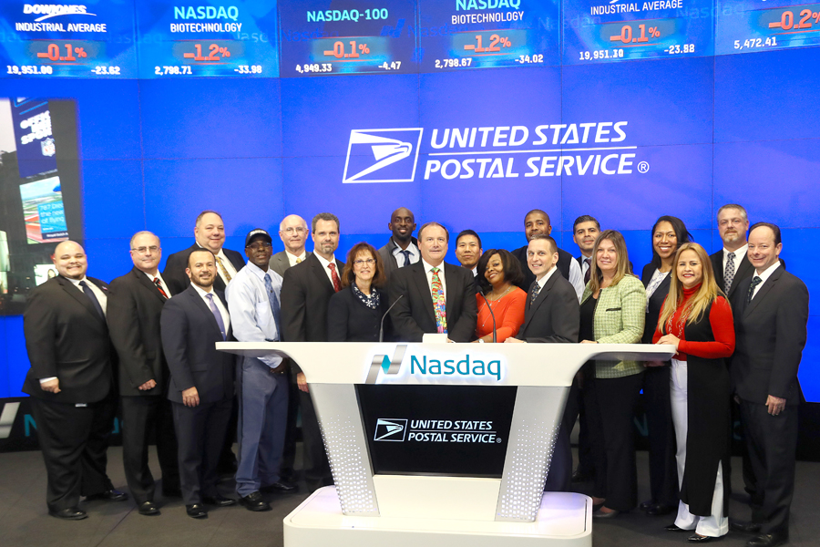 New York area postal employees ring the closing bell at the Nasdaq stock exchange Dec. 21, led by Northeast Area VP Ed Phelan Jr., who is standing in the center.