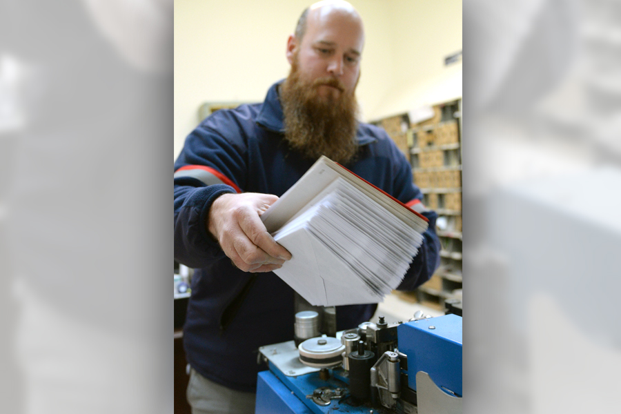 Chadwick Ruckart, a postal support employee in Bethlehem, MD, affixes the Post Office’s popular postmark to mail.
