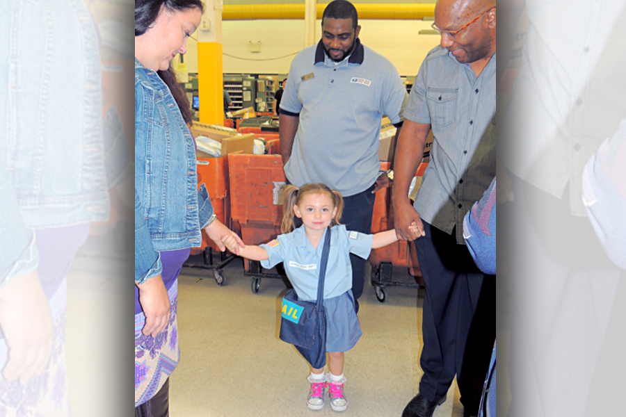 Jennifer Kraft and her daughter, Sophia, and husband, Kory, visit the Sewell, NJ, Post Office this year.